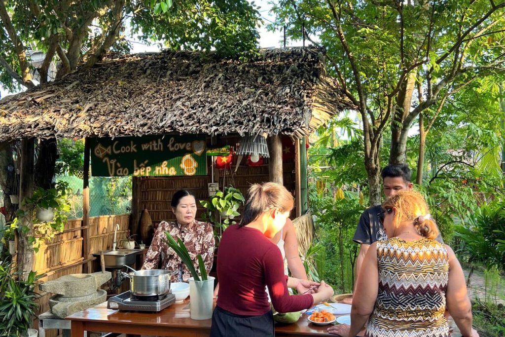Guests at the outdoor cooking station by the garden.