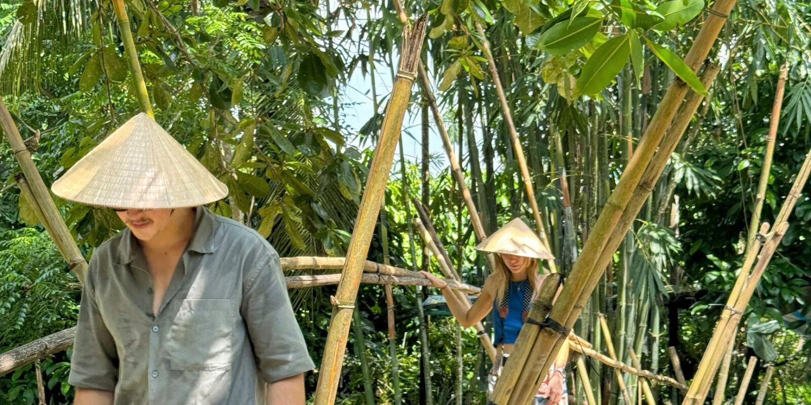 Walking the bamboo grove in conical hats.