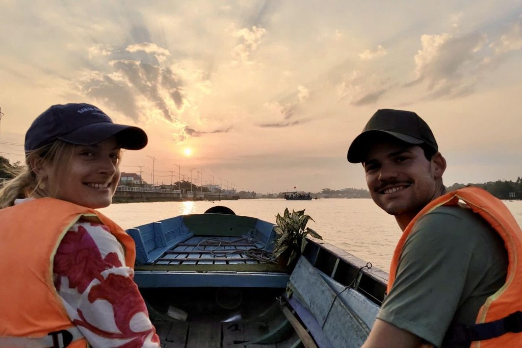 Sunset boat ride with guests in life jackets.