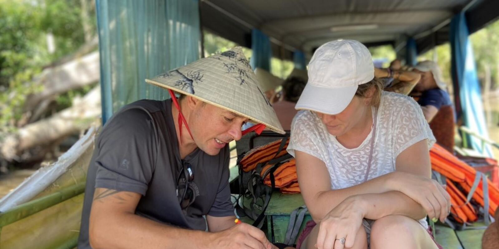 Guests on a boat trip, reading the map together.