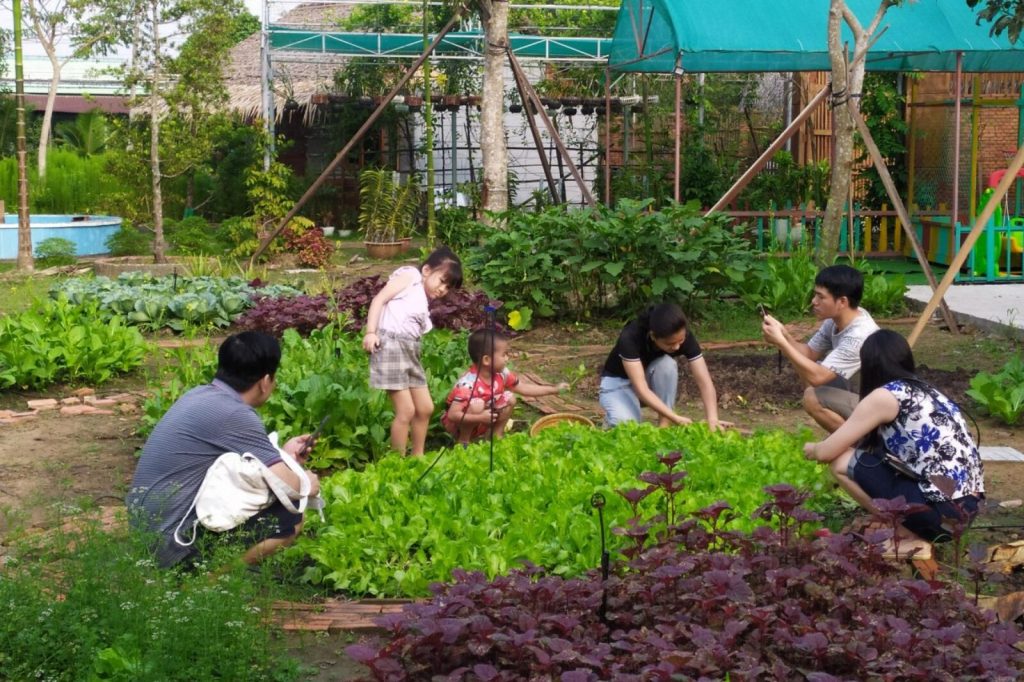 Guests planting in the vegetable garden.