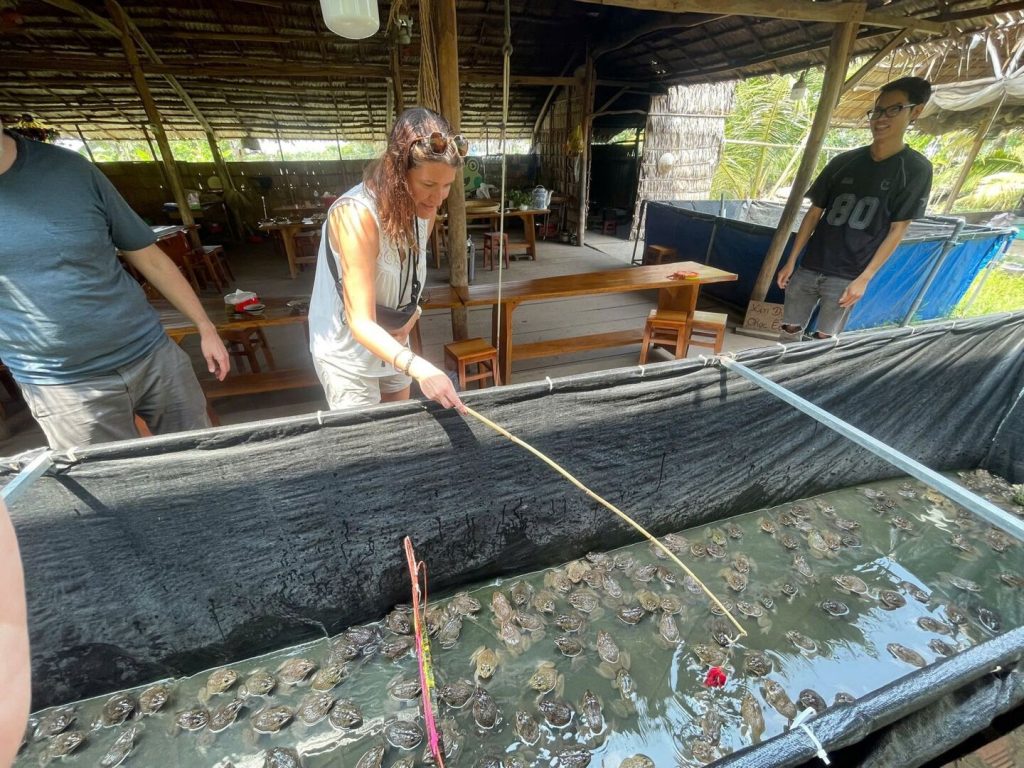 Feeding fish at a farm pond.