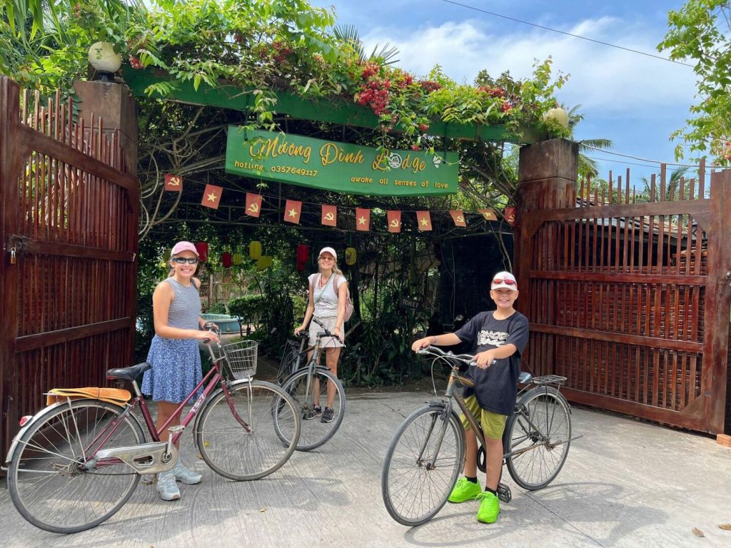 Guests with bicycles at the lodge gate.
