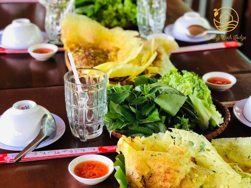 Crispy yellow pancakes served with fresh herbs, lettuce and dipping sauce.