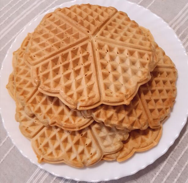 A plate of golden heart-shaped waffles.