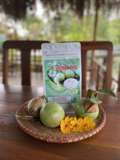 A pack of dried grapefruit peel on a woven tray with green fruit and yellow flowers.
