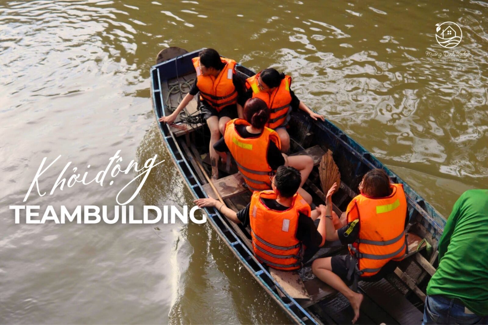 A boat of people in life jackets on a canal, captioned as a teambuilding warm-up.