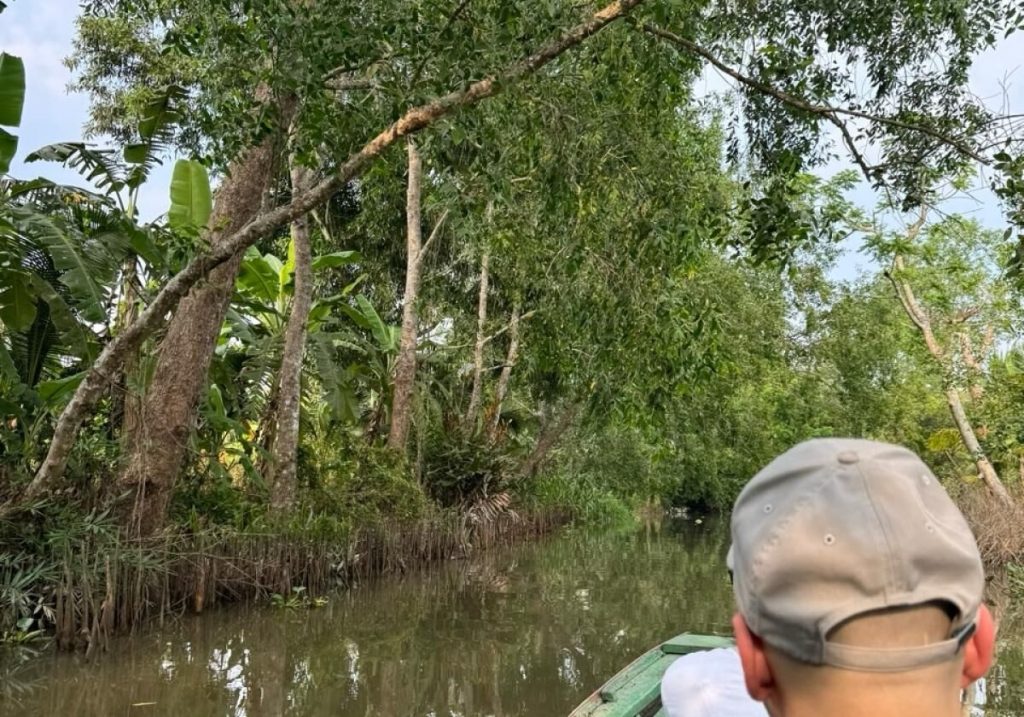 The tree-lined canal, seen from a boat.