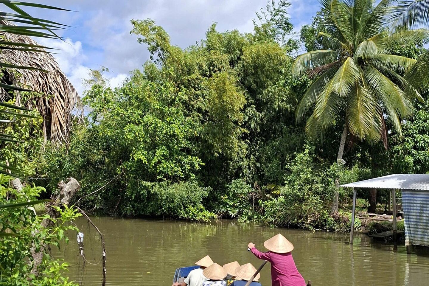 Woman rowing a boat on the canal.