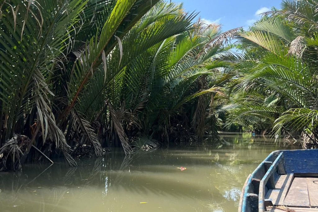 Nipa palm canal with a moored boat.