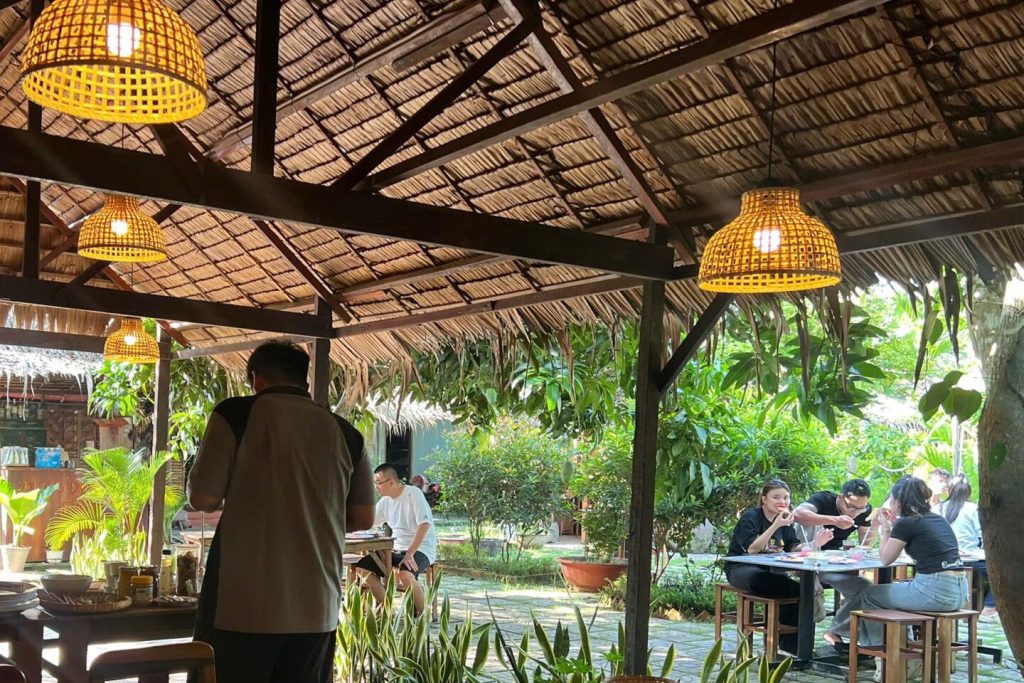 The thatched restaurant pavilion with its woven lamps.