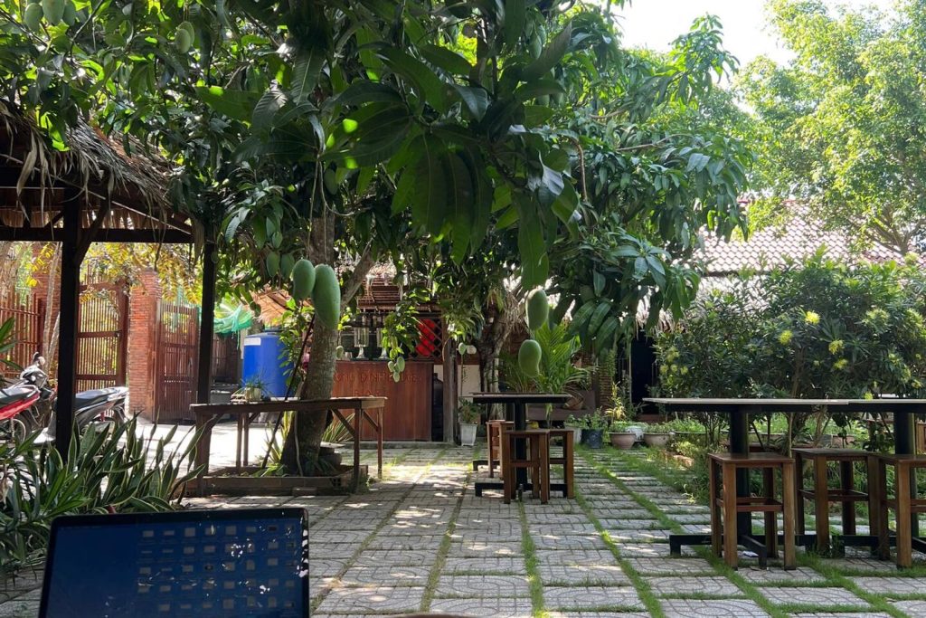 Garden courtyard with tables under the trees.