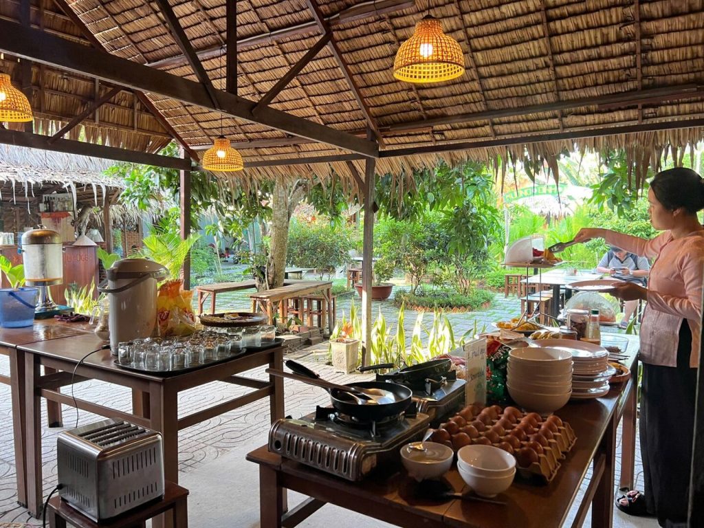 The outdoor cooking station under the thatched pavilion.