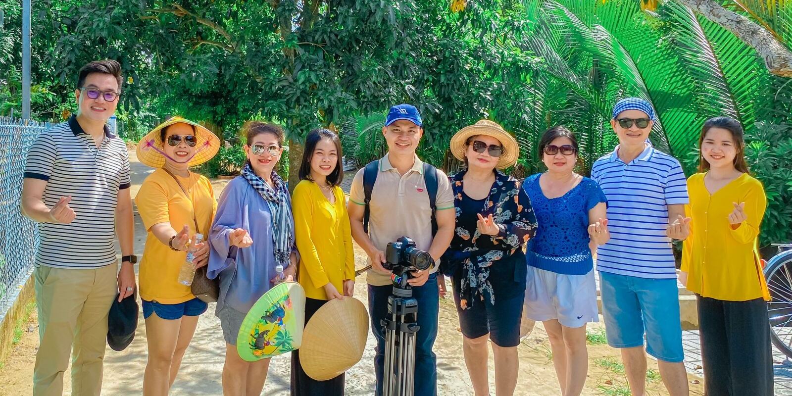 A tour group in conical hats in the lodge garden.