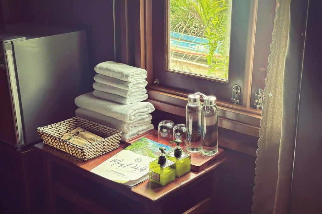 Towels, toiletries and water by the room window.