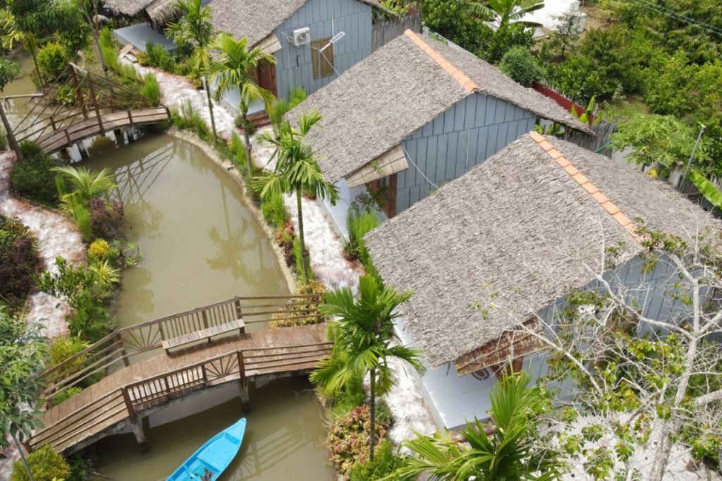 Aerial view of bungalows, canal and footbridge.